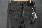 Dark denim pants with heart back pockets, button fly, and hanging tag