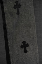 Black denim pants with two cross patches along the leg