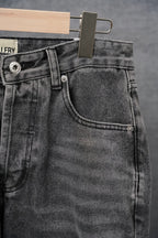 Black denim jeans front pocket with coin-style stitch detail and belt loops