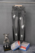 Dark gray denim pants with white cross patches, front view on hanger