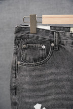 Black denim jeans pocket with metal buttons and stitched waistband yoke