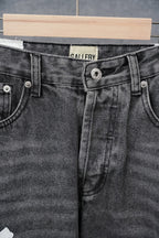 Black denim jeans waistband with GALLERY label and snap button closure