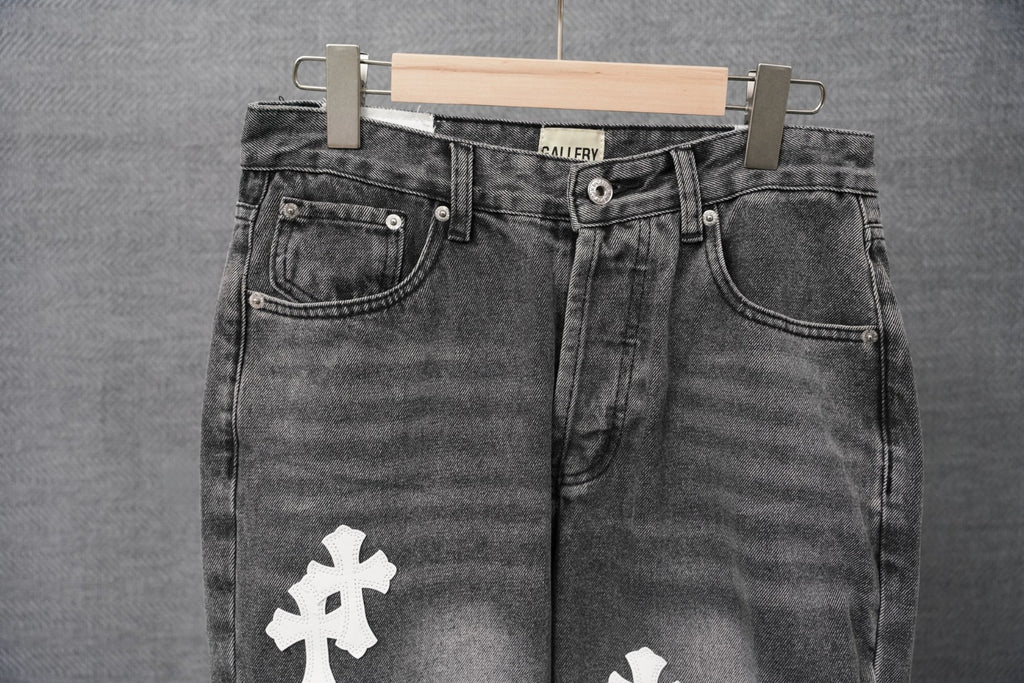 Black denim jeans with back yoke seam and white cross patch on thigh