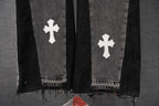 Black denim pants with white cross patches and frayed cuff hem
