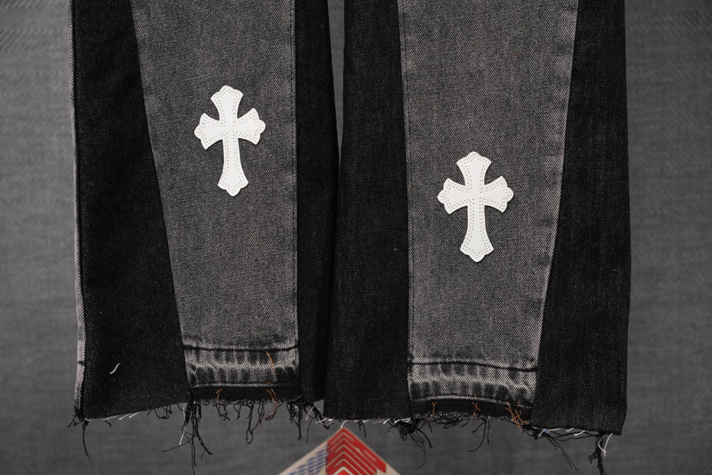 Dark gray denim pants with white cross patches, distressed frayed hem
