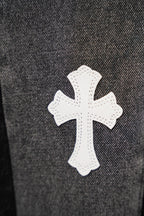 Black denim jeans with white cross patch applique on leg