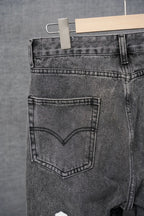 Dark gray denim pants, close-up of heart-shaped front pocket