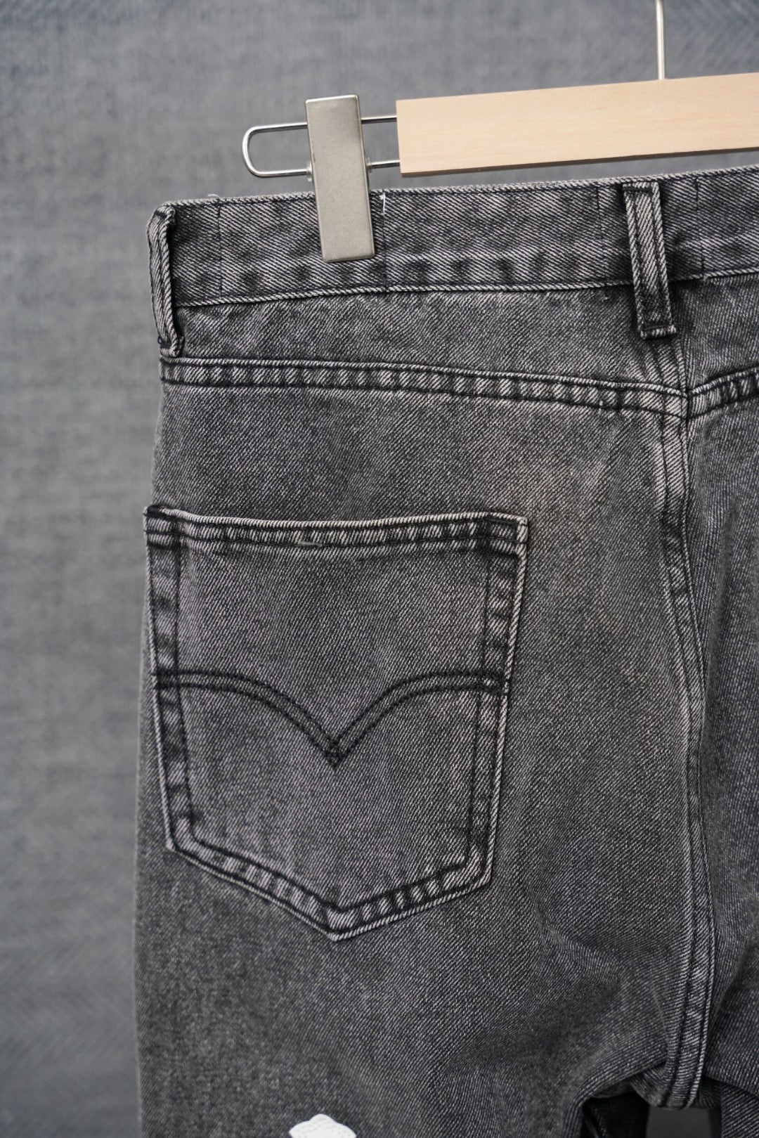 Dark gray denim pants, close-up of heart-shaped front pocket