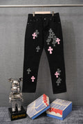 Black pants with pink crosses and checkered cross patches; button closure waistband.