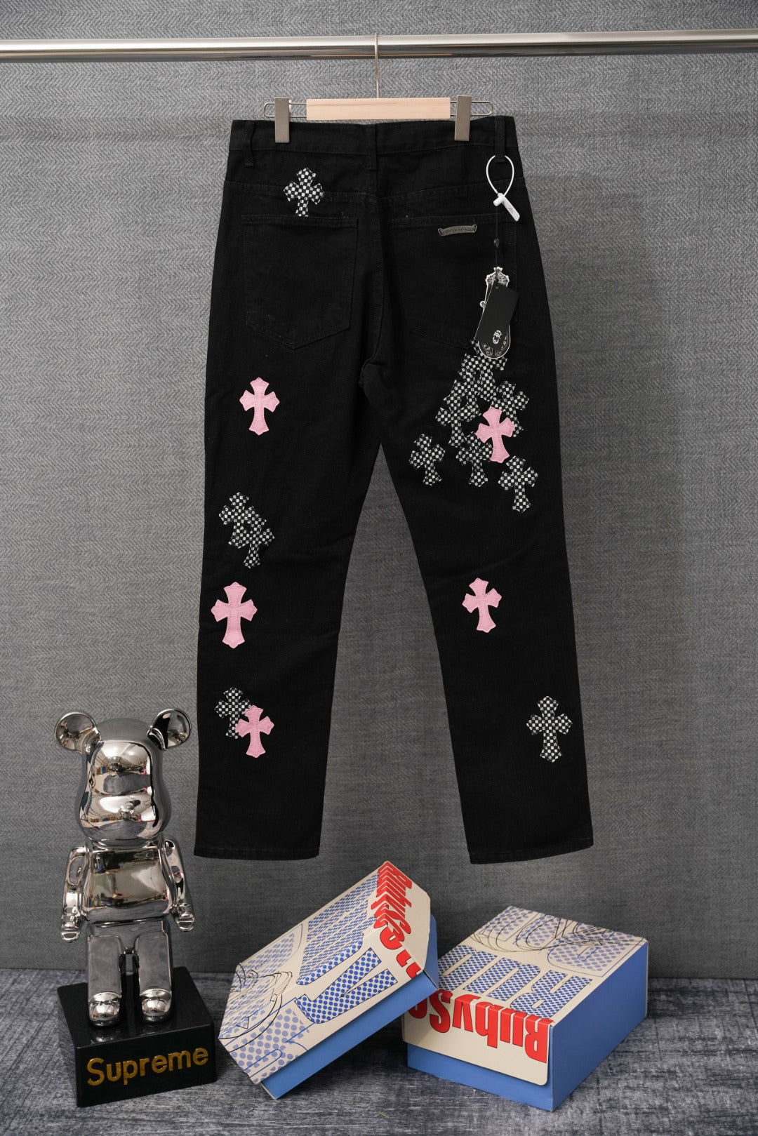 Black pants with pink and checkered cross patches, relaxed leg, belt loops
