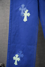 Blue Chrome pants leg with stitched seam and cross patches near the knee