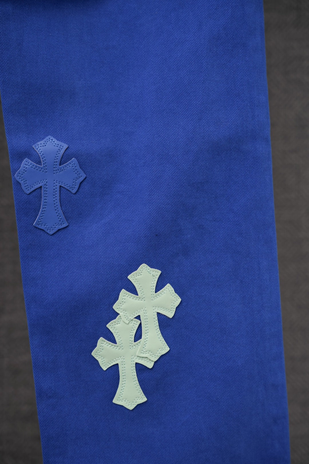 Chrome pants in blue with three cross applique patches on the leg