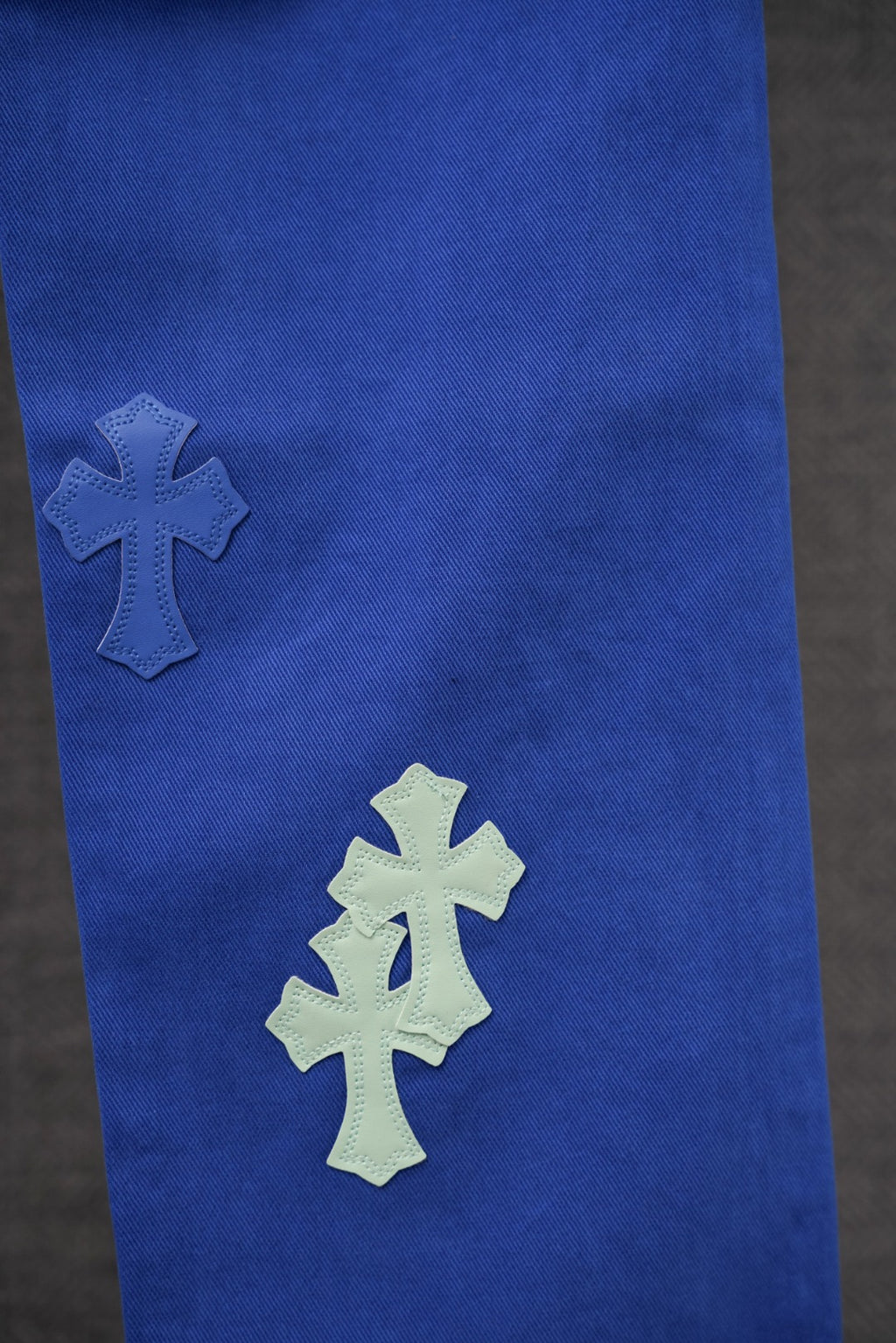 Blue pants with large cross patches on leg