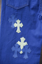 Chrome pants in blue with multiple cross applique patches near the pocket