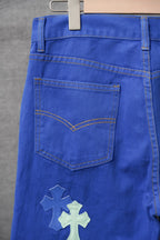 Blue pants with front pocket and stitched yoke, cross patch near hem