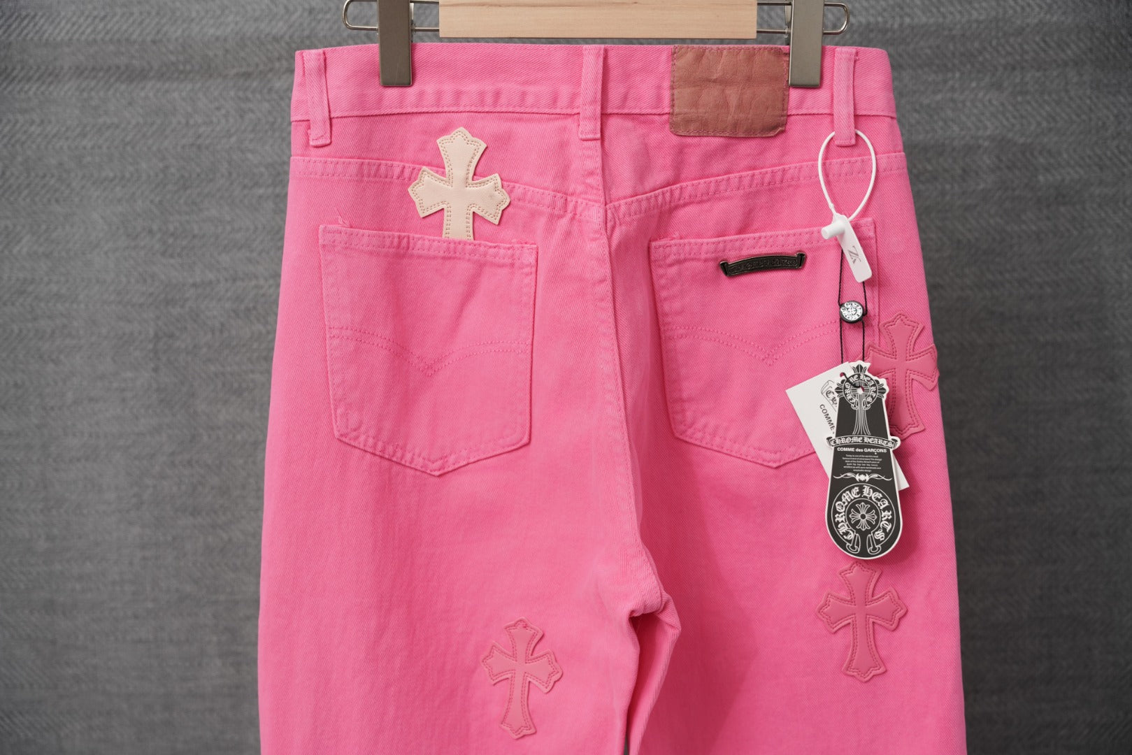 Pink chrome pants, button fly, front pockets, and cross patch embroidery.
