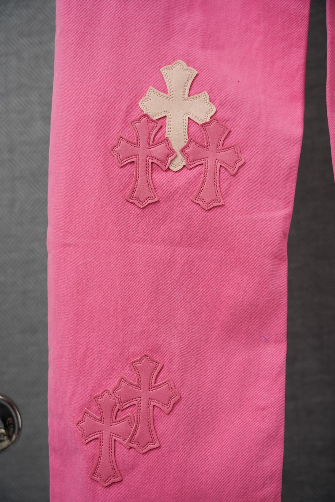 Pink pants side with small stitched cross appliques
