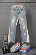Light wash denim pants with white cross patches and distressed hem