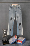 Light-wash denim pants with black cross patches and frayed hems