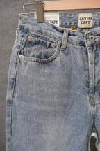 Light wash denim jeans close-up: front patch pocket and button detail