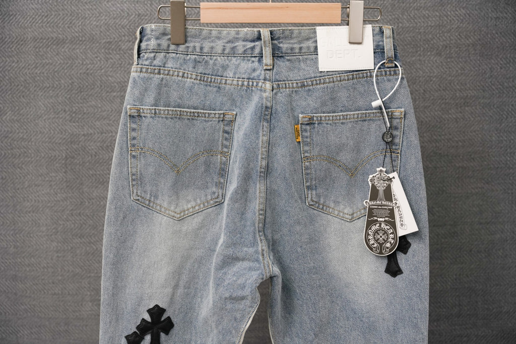 Light wash denim jeans with front pockets and keychain tag on waistband