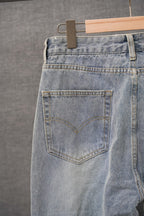 Light-wash denim pants with back patch pocket, belt loops, and straight waistband