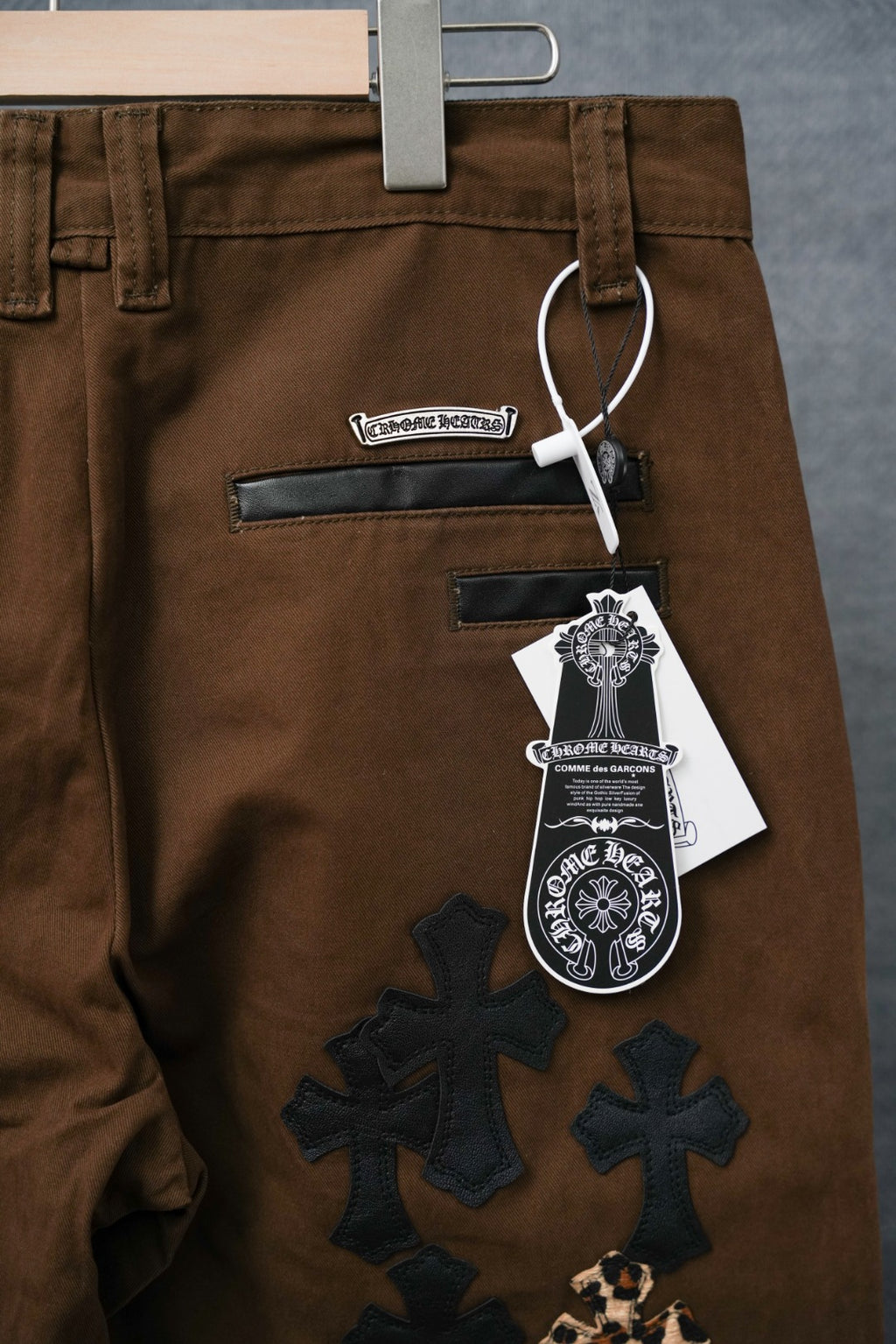 Brown pants with large cross appliques in dark blue and leopard print