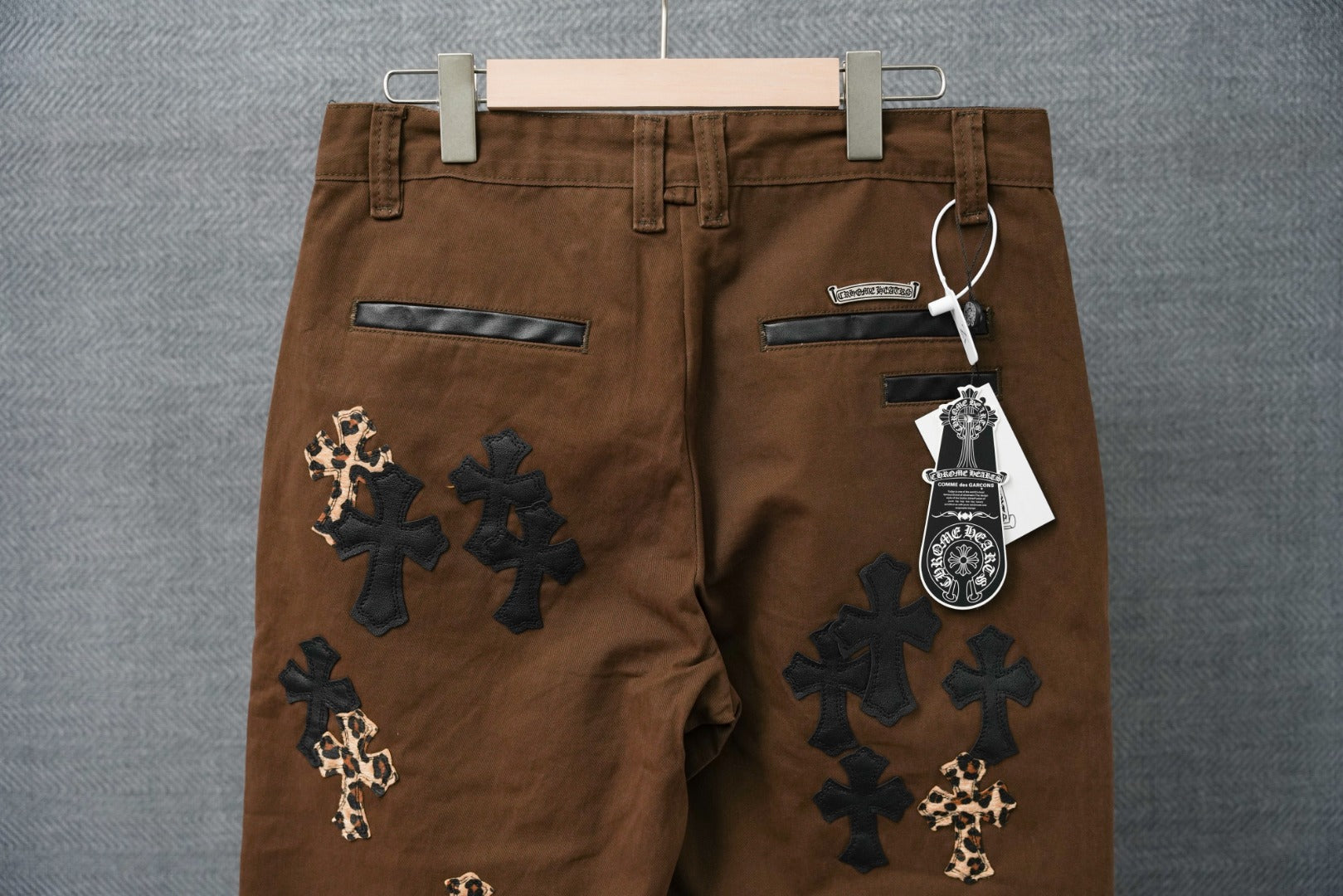 Brown pants with back pockets and cross patches in dark with leopard-print accents