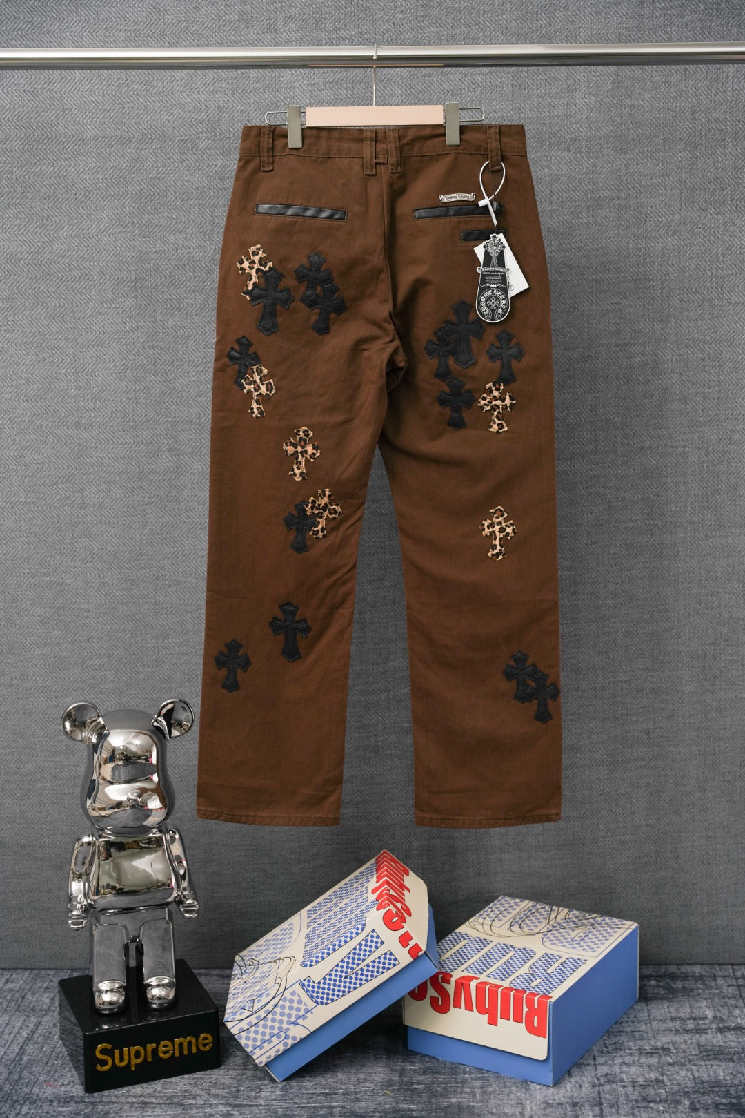 Brown pants with dark cross patches and leopard-print cross appliques at front
