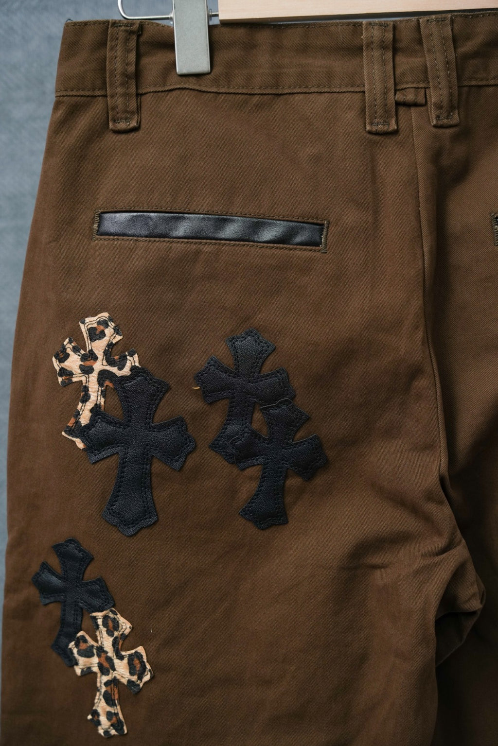 Brown pants with rectangular patch and cross appliques in dark denim and leopard