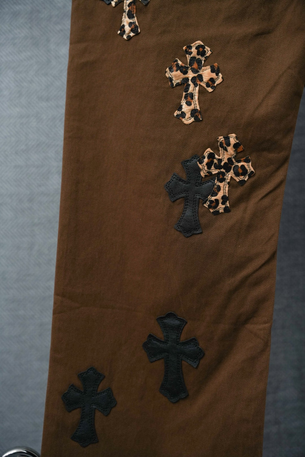 Chrome pants in brown with cross patches on legs and leopard-print accents