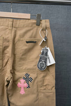 Beige cargo pants with belt loops, front panel, and cross appliques near pockets