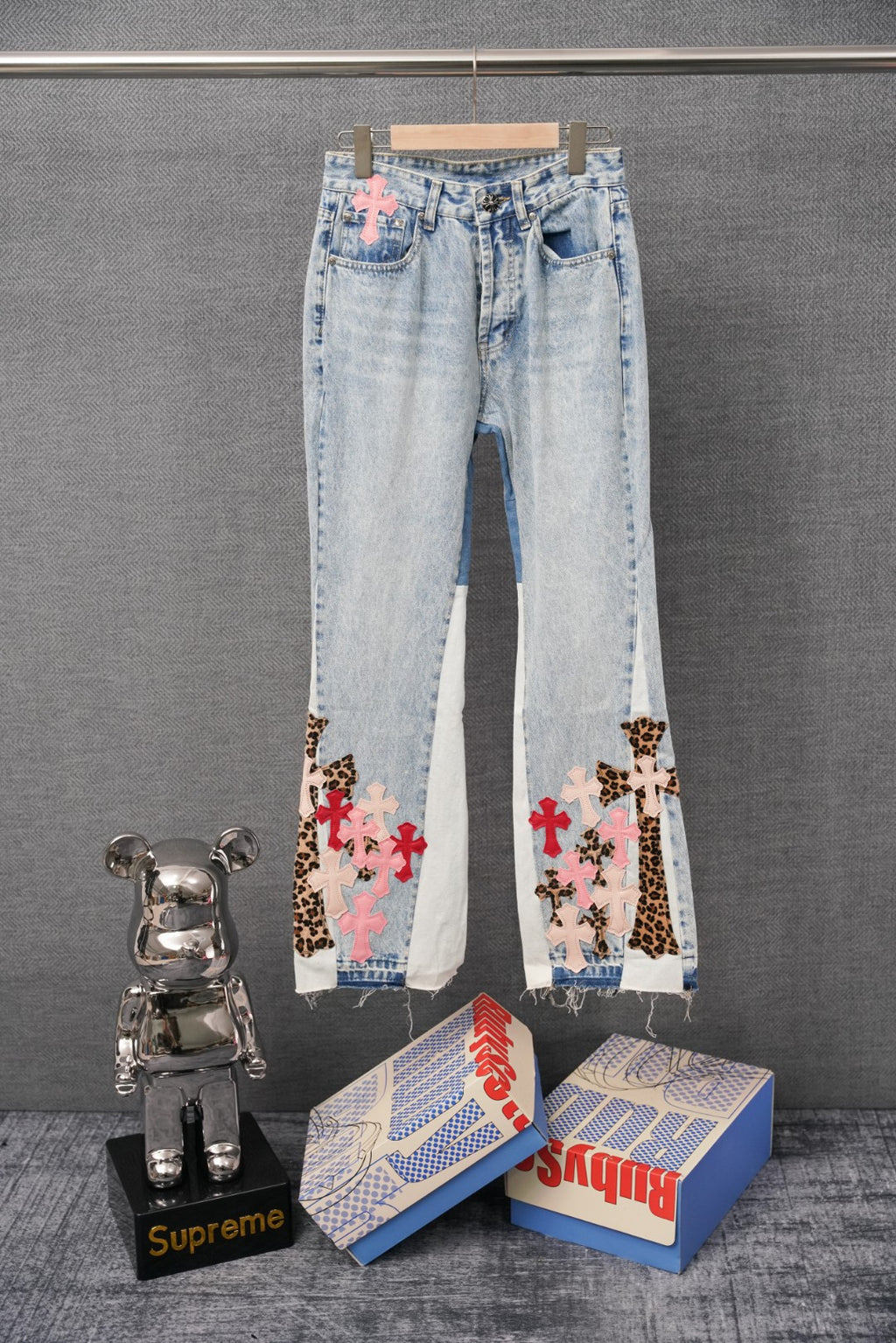 Light blue denim pants with cross patches and leopard-print side panels