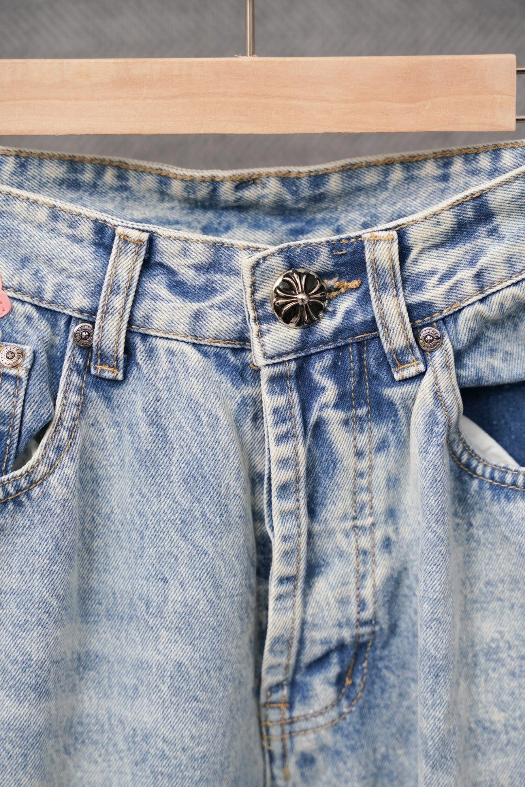 Light blue denim waistband and front pockets with dark floral button