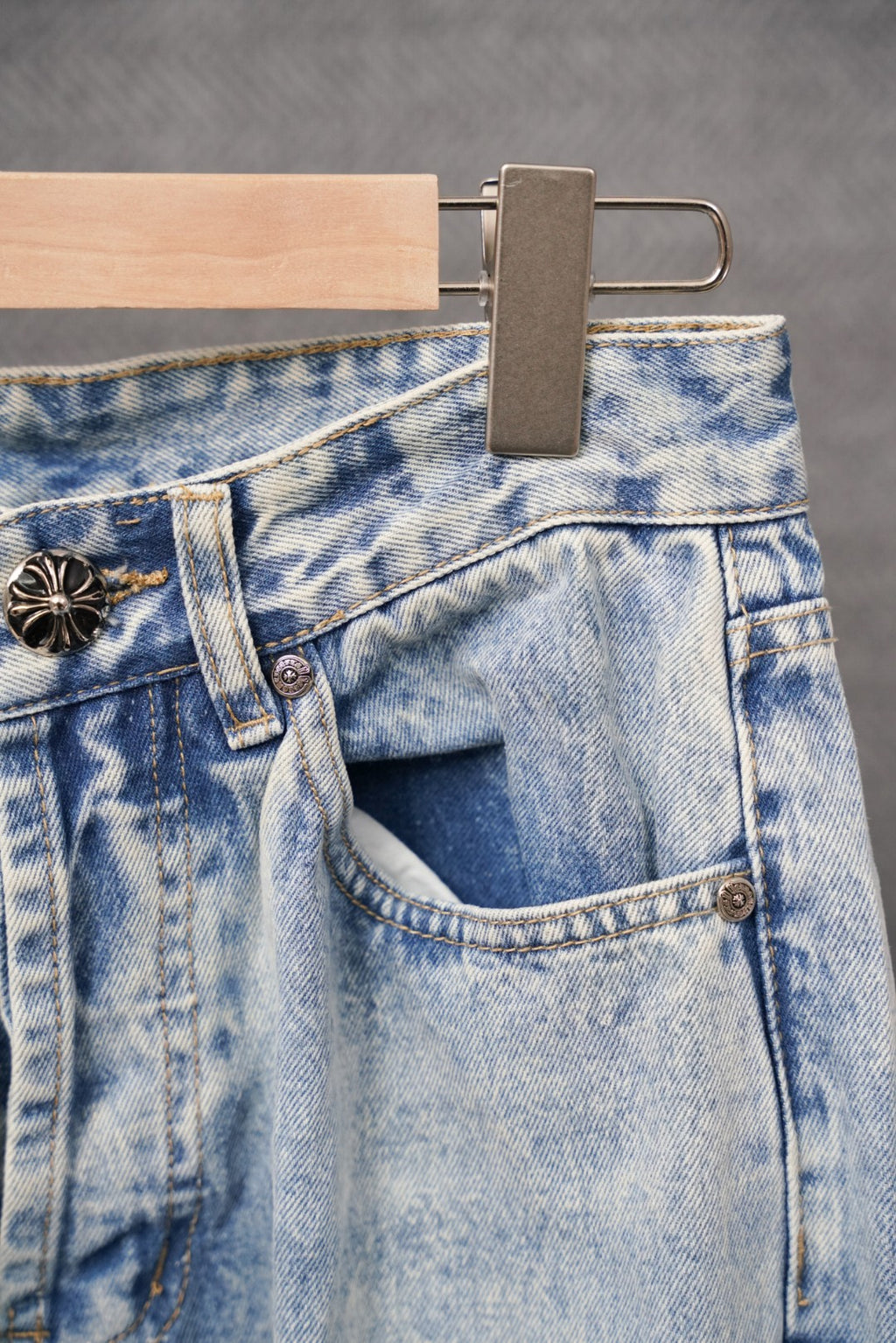 Light blue denim waistband with dark button and belt loops