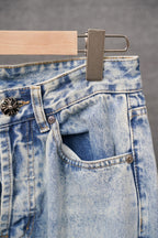 Light-wash denim pants with side pocket opening and metal button accents