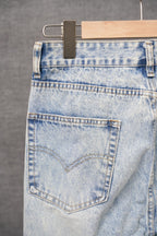 Light blue denim pants with stitched back pocket and distressed wash