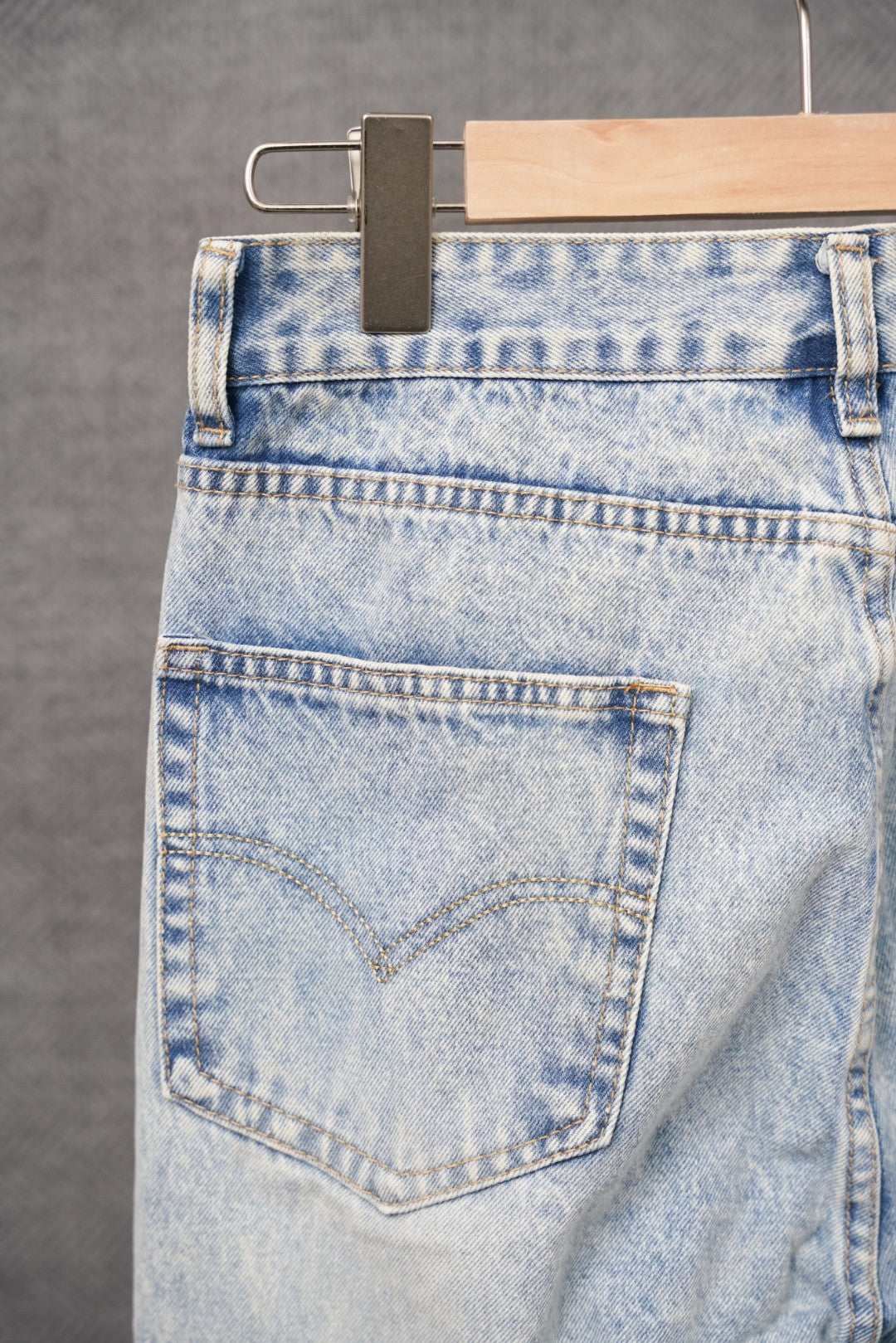 Light blue denim pants with stitched back pocket and distressed wash