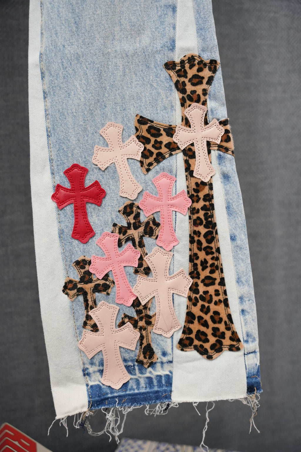 Light blue denim with leopard-print insert and pink, red, white cross patches