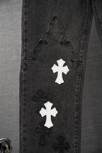 Black denim pant leg with large outline applique and white cross patch