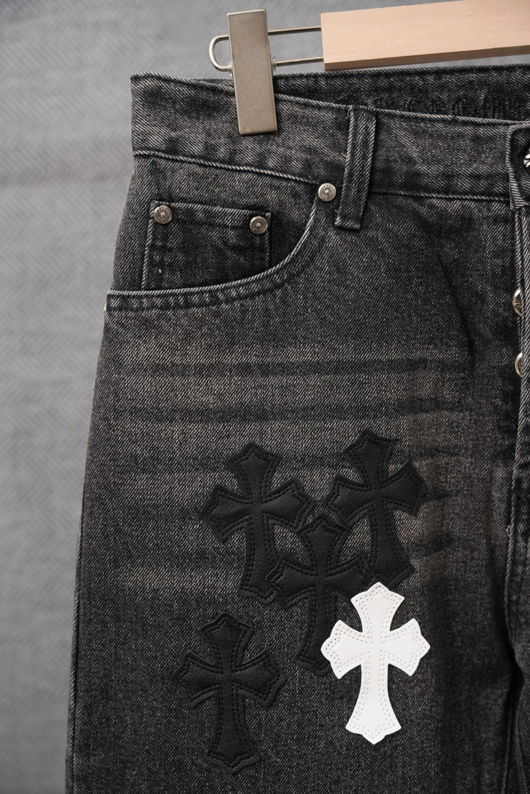 Black denim pants with front pocket, dark cross motifs and one white cross