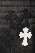 Chrome pants, denim fabric close-up with black and white cross embroidery patches