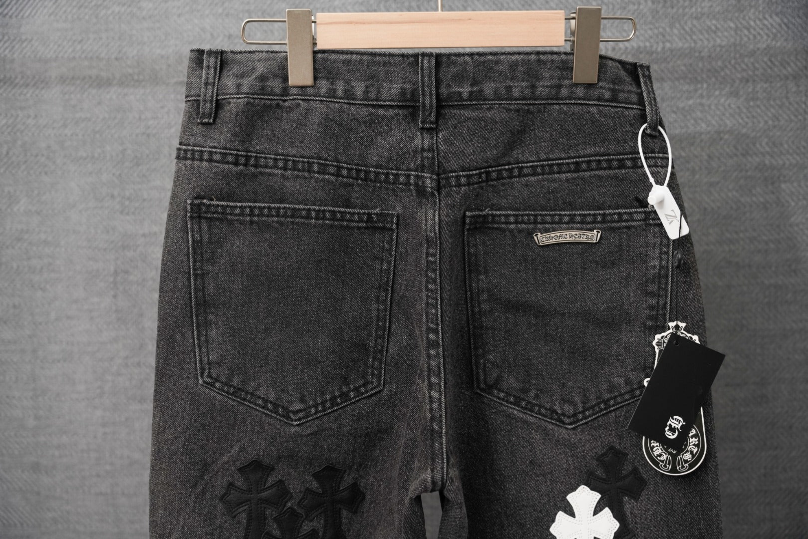 Dark denim pants with back pockets and small logo patch detail