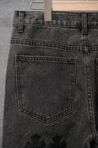 Black denim pants back with stitched pocket panel and belt loops, close-up