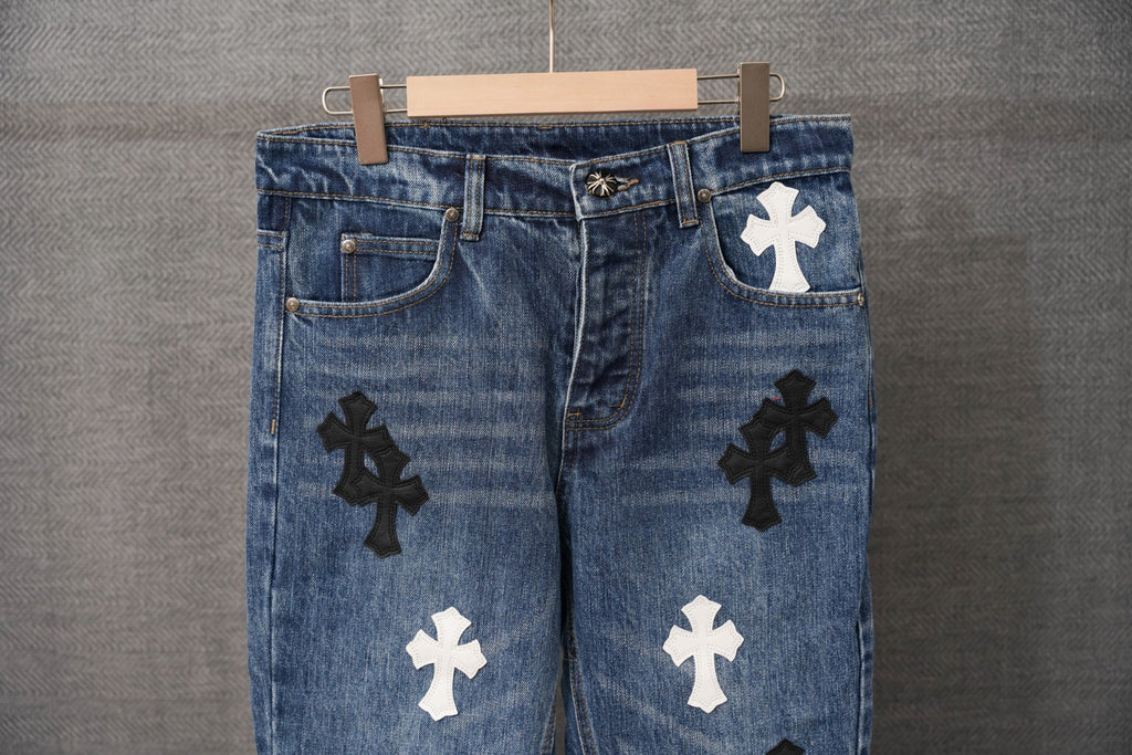 Blue denim pants close-up of front with cross patch on the right thigh