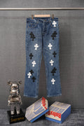 Blue denim pants with scattered white and black cross patches