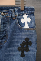 Blue denim pants close-up of side pocket with white cross patch
