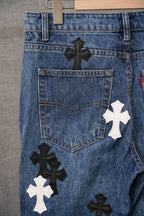 Blue denim pants with cross appliques and large front patch pocket