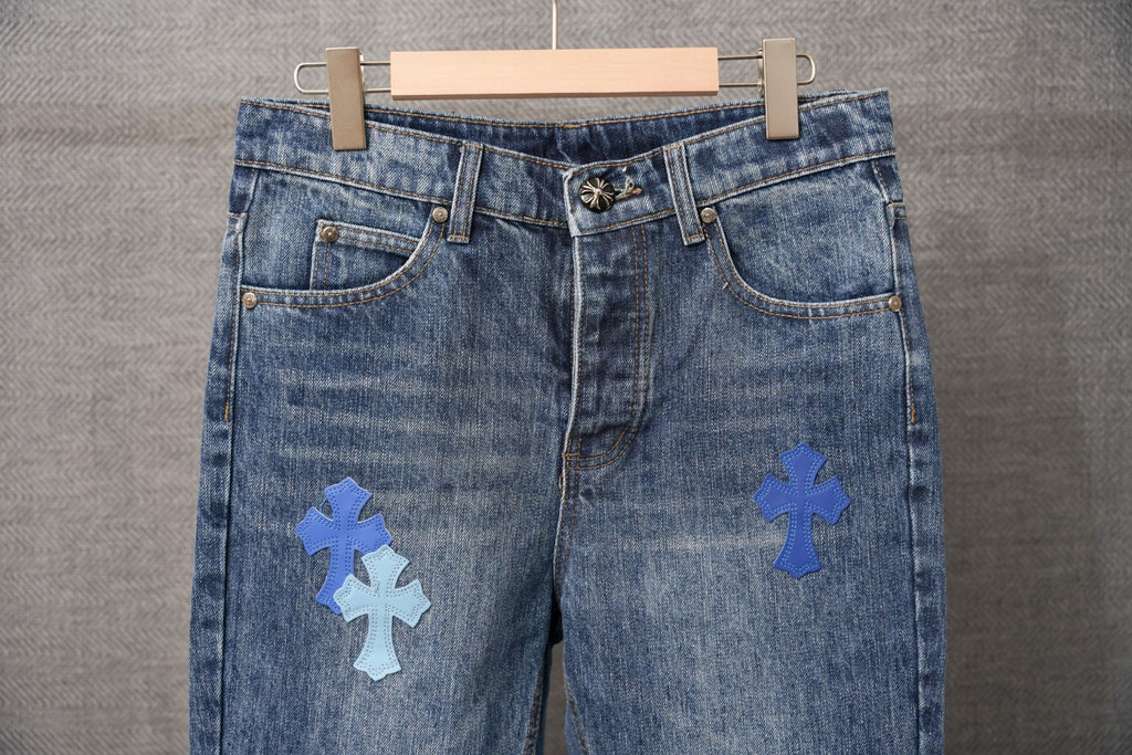 Chrome denim pants with blue cross patches, front close-up view