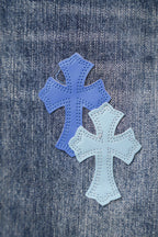 Chrome denim pants close-up of three blue cross patches